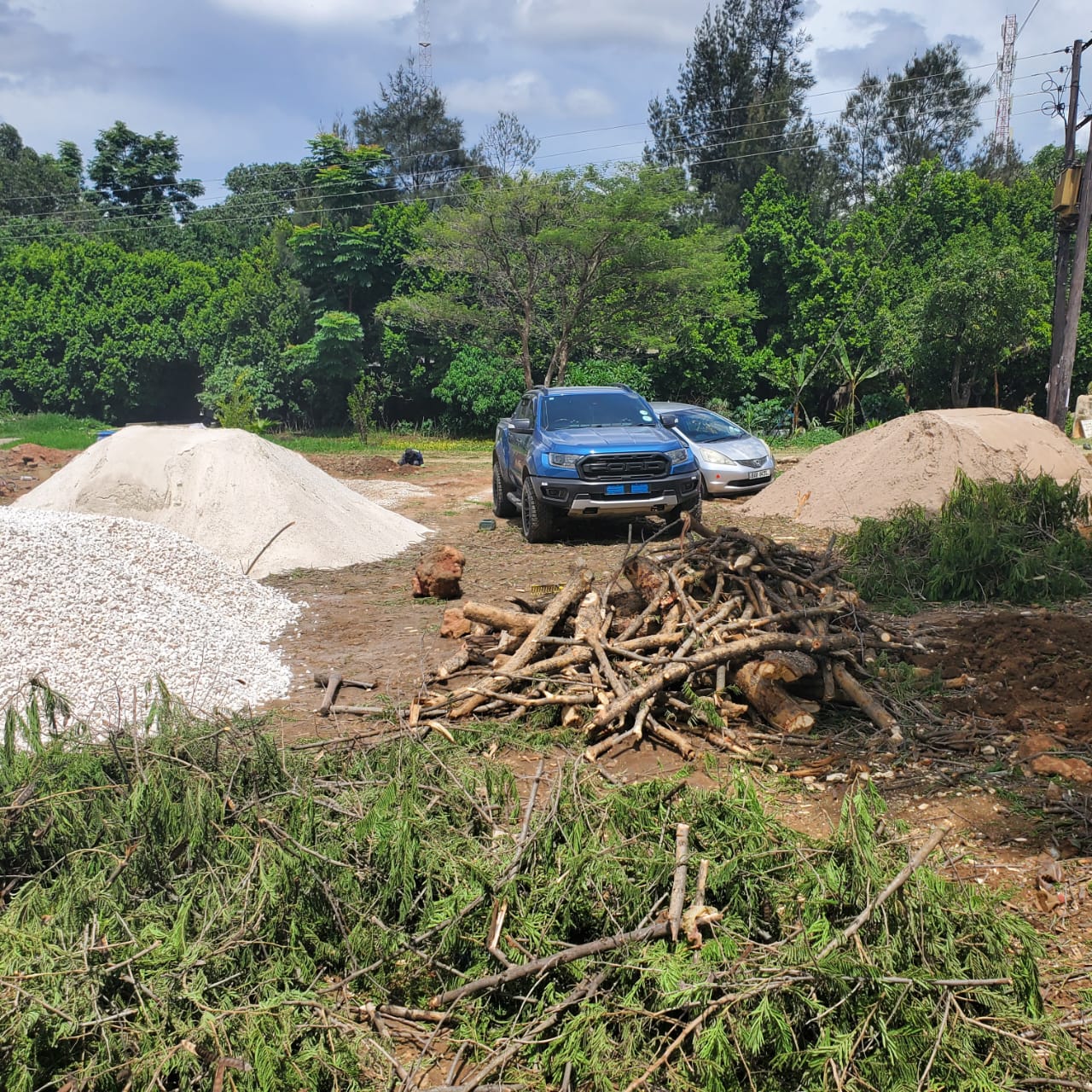 Stockpiles of sand, stone and aggregate on a cleared site
