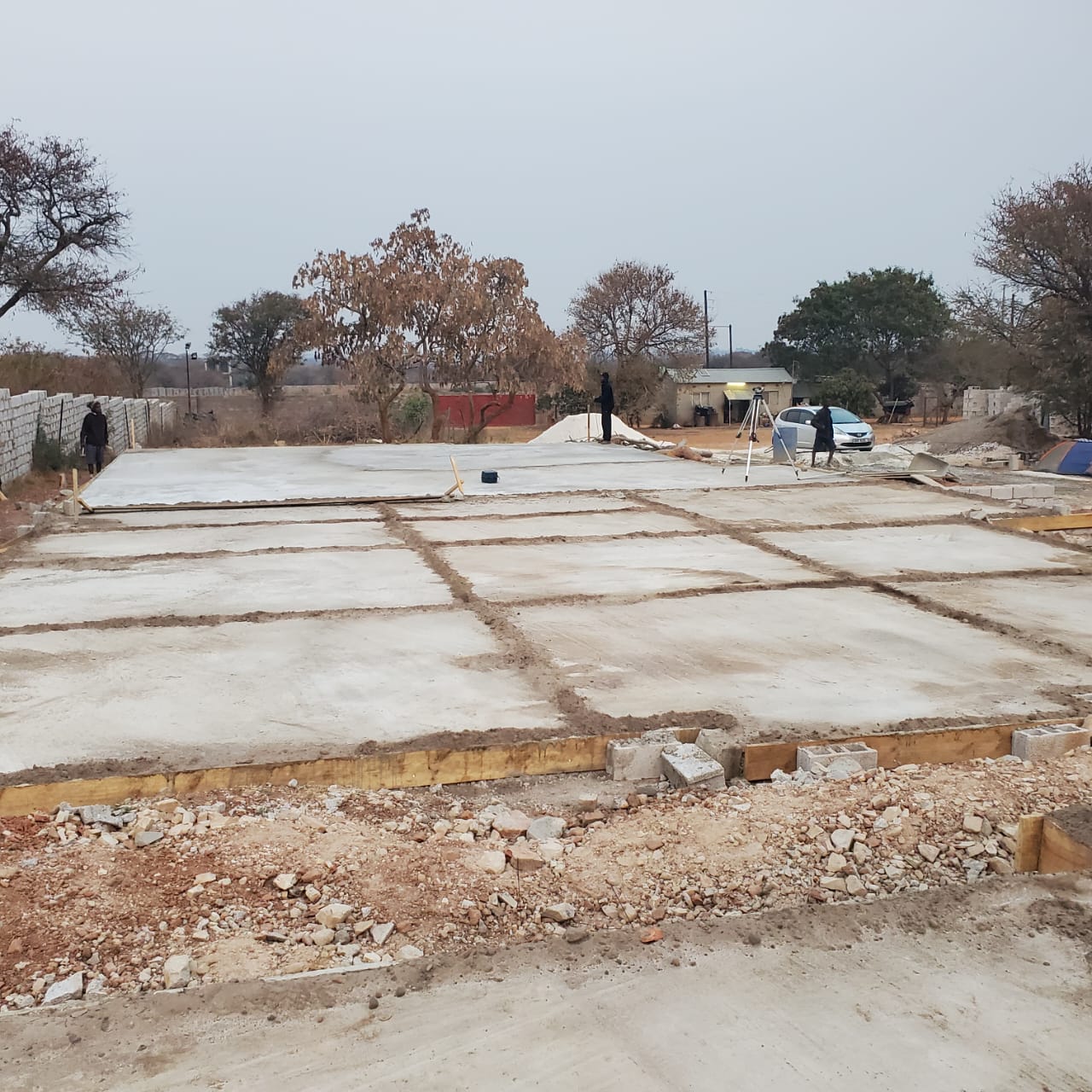 Ground floor slabs cast in bays across the footprint of the flats, level set up on site