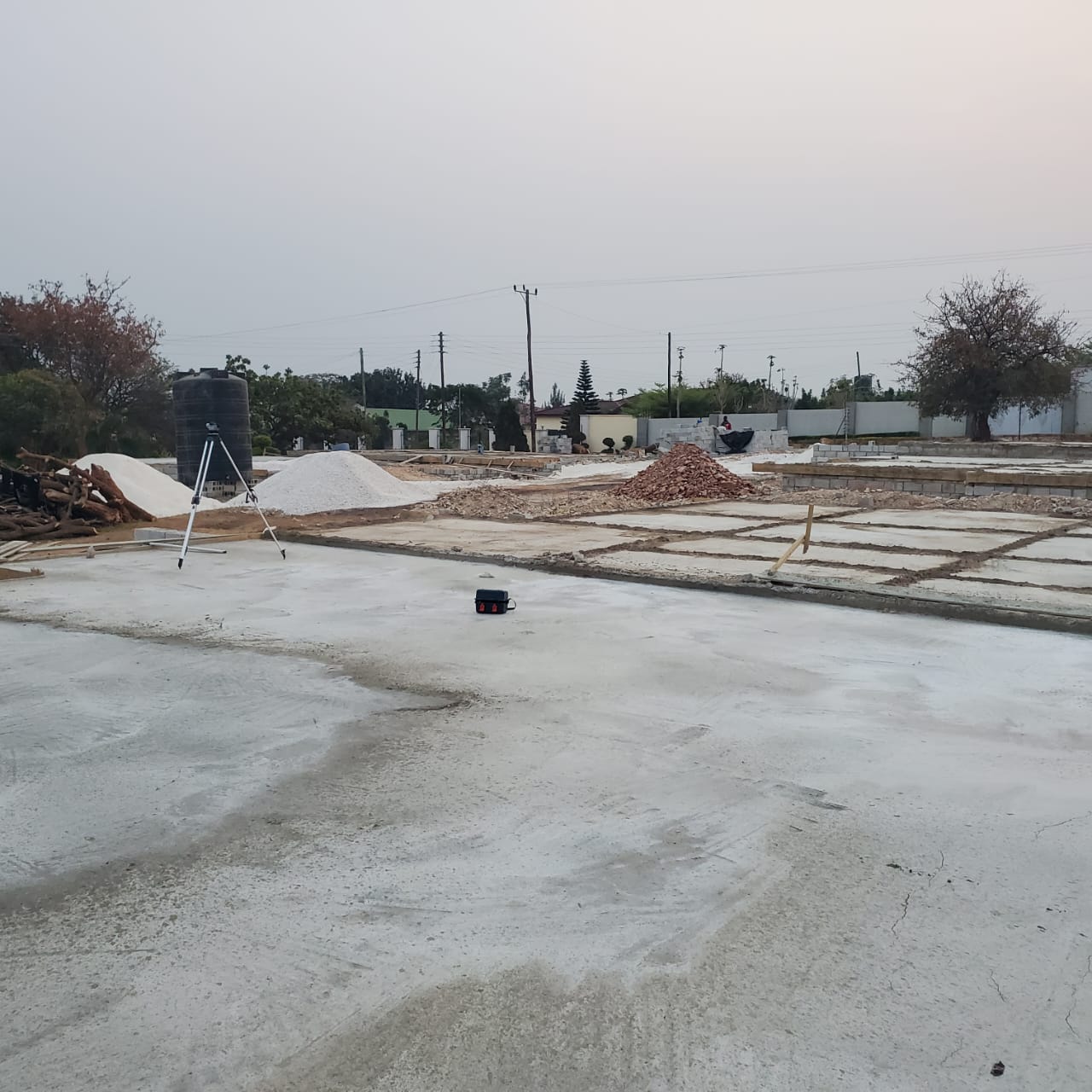 Floor slabs cast across the second block of flats with materials stockpiled behind