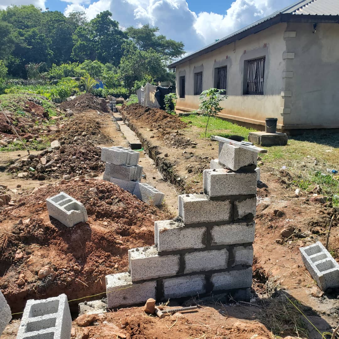 Foundation blockwork rising off the strip footing beside the house