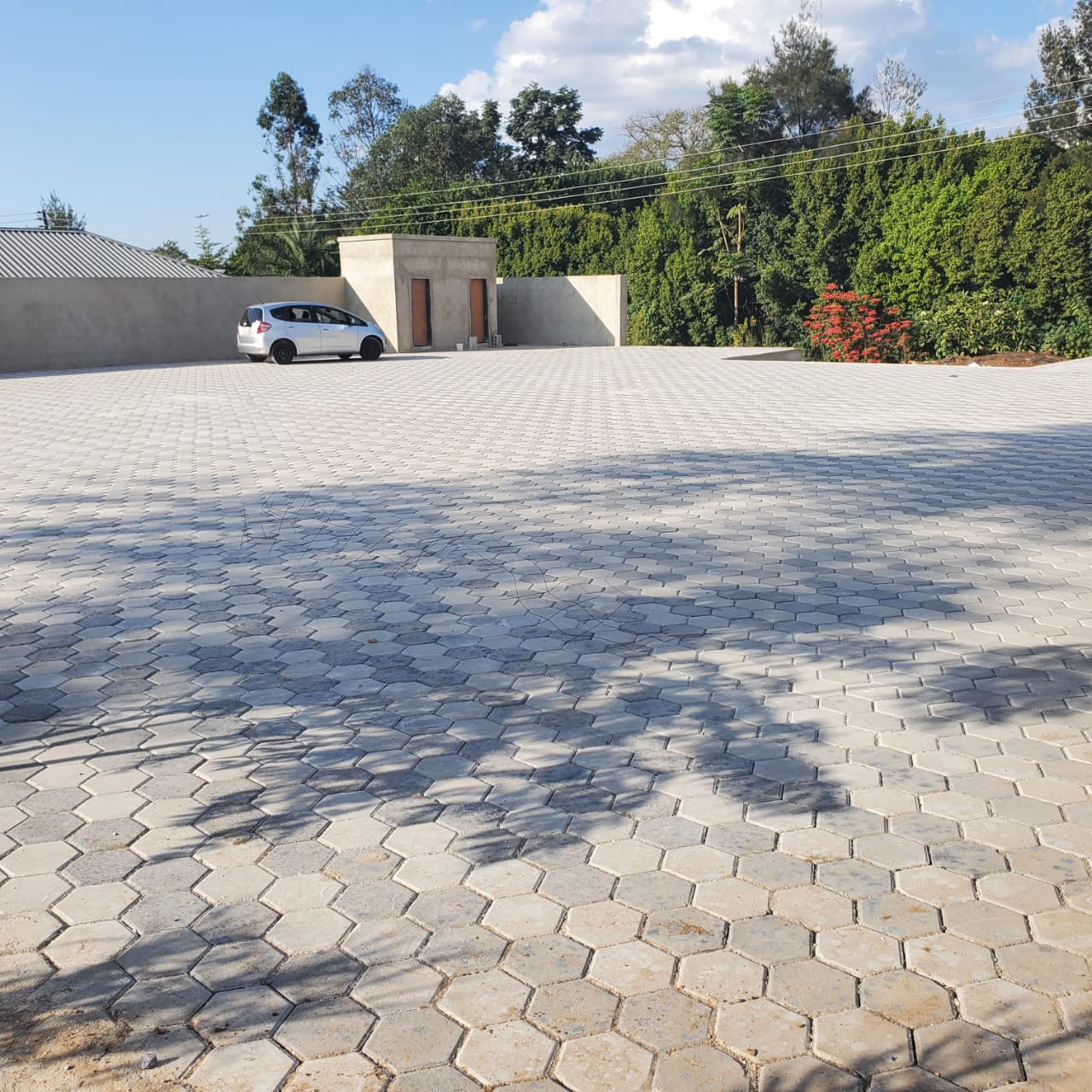 Completed paved forecourt with boundary wall and gatehouse