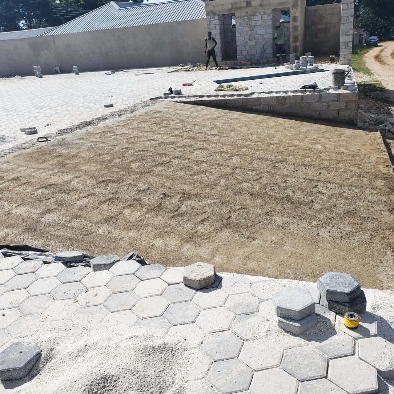Sand bedding screeded flat ahead of the next bay of paving